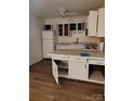 Kitchen with white cabinets, a center island and tile countertops at 7107 Stonington Ln, Charlotte, NC 28227