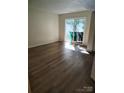 A sunlit living room with sliding glass doors and new wood-look floors at 7107 Stonington Ln, Charlotte, NC 28227
