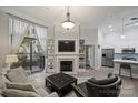 Light-filled living room boasts a fireplace, built-in bookshelves, and a sliding door to the balcony at 718 W Trade St # 105, Charlotte, NC 28202