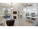 Bright living room with fireplace, built-in shelves, and an open layout with kitchen access at 718 W Trade St # 105, Charlotte, NC 28202