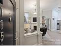 Inviting living room featuring a fireplace, built-in shelves, and stylish architectural columns near the front door at 718 W Trade St # 105, Charlotte, NC 28202