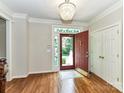 Welcoming foyer with hardwood floors, stained glass sidelights, and a view of the front yard at 8218 Houston Ridge Rd, Charlotte, NC 28277