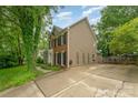 Spacious home exterior featuring a large driveway, mature landscaping, and neutral siding at 8624 Canter Post Dr, Charlotte, NC 28216