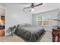 This bedroom features a gray quilt bed, a ceiling fan, and a bright window at 945 Heritage Pkwy, Fort Mill, SC 29715