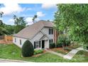 Well-manicured lawn of a home with neutral siding, complemented by dark shutters and a lush lawn at 945 Heritage Pkwy, Fort Mill, SC 29715