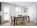 Bright dining room with wood floors, a large window and a table for six at 10124 Florentine Way, Charlotte, NC 28214