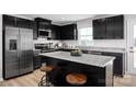 Stylish kitchen boasts an island with seating, stainless appliances, and ample storage at 10124 Florentine Way, Charlotte, NC 28214