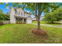 Charming home on a green lawn, showcasing mature trees and landscaping at 1023 Valley Ridge Rd, Charlotte, NC 28214