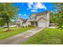 Charming two-story home with well-manicured front yard and driveway leading to an attached garage at 1023 Valley Ridge Rd, Charlotte, NC 28214