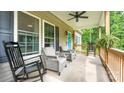 Inviting covered front porch with comfortable rocking chairs and ceiling fan at 119 Wade Dr, Kings Mountain, NC 28086