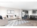 Open-concept living room flows into kitchen with dark cabinets, stainless steel appliances, and a center island at 12109 Beaux Art Ln, Charlotte, NC 28214