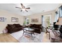 Cozy living room features two plush sofas, a stylish glass-top coffee table, and bright natural light from the windows at 122 Pratt St, Belmont, NC 28012