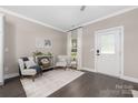Cozy living area with natural light, comfortable seating, dark wood floors, and neutral wall color at 12220 Huntersville Concord Rd, Huntersville, NC 28078