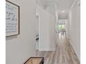 Inviting hallway with wood-look floors, crown molding and views into the living area at 1344 Sweet Pea St, Monroe, NC 28110