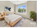 Staged primary bedroom featuring a bright window, neutral tones, and a comfortable bed at 14123 Tranters Creek Ln, Charlotte, NC 28273