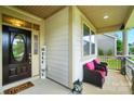 Cozy covered porch featuring comfy wicker chairs and charming decor elements for a relaxing atmosphere at 16213 Kelby Cv, Charlotte, NC 28278