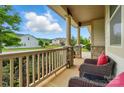 Spacious covered porch with ample seating, perfect for enjoying outdoor views and a peaceful setting at 16213 Kelby Cv, Charlotte, NC 28278