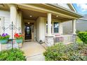 Inviting front porch with stone accents, columns, and beautiful landscaping for a warm welcome at 16213 Kelby Cv, Charlotte, NC 28278