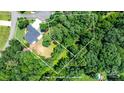 Aerial view of property showcasing the house and surrounding trees with estimated property outline at 1819 Brompton Ct, Newton, NC 28658