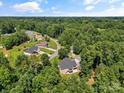 Aerial view of a neighborhood with a house and a lush tree canopy surrounding the homes at 1819 Brompton Ct, Newton, NC 28658