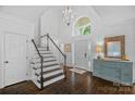Bright foyer with soaring ceilings, dark hardwood floors, and staircase with white railings at 20312 Deep Cove Ct, Cornelius, NC 28031
