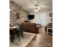 Open concept living and dining area with hardwood floors and abundant natural light, showcasing a comfortable seating area at 205 Wellington Hills Cir # 205, Salisbury, NC 28147