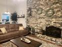 Inviting living room featuring a brick accent wall, cozy fireplace, and comfortable seating arrangement at 205 Wellington Hills Cir # 205, Salisbury, NC 28147