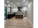 Open kitchen boasts stainless appliances, an island, and a door leading to an outdoor space at 2412 Kingsbury Dr, Charlotte, NC 28205
