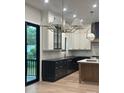 Bright kitchen with stainless steel appliances, large island and modern light fixtures at 2412 Kingsbury Dr, Charlotte, NC 28205