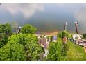 Aerial view showcasing the waterfront home, dock, and lush greenery along the shoreline at 270 Yachtsman Dr, Salisbury, NC 28146