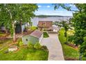 Beautiful home with a two-car garage, carport, and waterfront views from its lush green lawn at 270 Yachtsman Dr, Salisbury, NC 28146