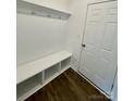 Functional entryway with bench seating, coat hooks, and durable vinyl floors at 353 Jetton St, Davidson, NC 28036