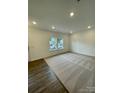 Inviting living room boasting cozy carpet flooring and natural light from surrounding windows at 353 Jetton St, Davidson, NC 28036