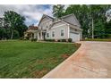 A lovely two-story home with a well-kept lawn and an attached garage at 360 Sundown Rd, Mooresville, NC 28117