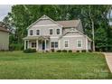 Well-maintained two-story home with a pristine lawn and mature trees at 360 Sundown Rd, Mooresville, NC 28117