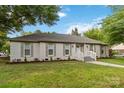 Beautiful single-story home showcasing a well-maintained lawn, decorative shutters and mature trees at 3801 Rea Rd, Charlotte, NC 28226