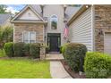 Charming home featuring a stone and vinyl exterior, well-manicured landscaping, and a modern door at 4121 Cedar Point Ave # 28, Stallings, NC 28104