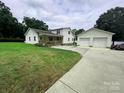 Charming two-story home with a well-maintained lawn and detached two-car garage offers ample space and curb appeal at 4574 Ivy Run Ln, Denver, NC 28037