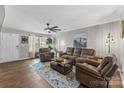 Spacious living room with hardwood floors, a ceiling fan, and comfortable seating, creating an inviting atmosphere at 515 Benford Ln, Stanley, NC 28164