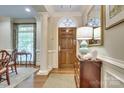 Elegant foyer with hardwood floors, arched doorway, and decorative molding at 525 Queens Rd, Charlotte, NC 28207