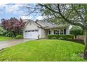 Charming home with well-maintained lawn, mature trees, and inviting curb appeal on a sunny day at 5927 Leawood Run Ct, Charlotte, NC 28269