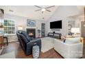 Bright living room with a vaulted ceiling, cozy fireplace, and stylish furnishings for comfortable living at 5927 Leawood Run Ct, Charlotte, NC 28269