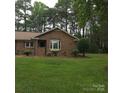 Charming brick home featuring a well-manicured lawn, mature trees, and inviting curb appeal at 600 Colby Cir, Salisbury, NC 28147