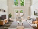 Inviting living room features high ceilings, french doors, and stylish decor at 7609 Holly Grove Ct, Charlotte, NC 28227