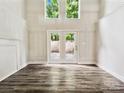 Bright living room with high ceilings, french doors, and dark wood flooring at 7609 Holly Grove Ct, Charlotte, NC 28227