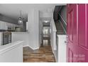 Inviting entryway featuring hardwood floors and staircase leading to the upper level at 7943 Mariners Pointe Cir, Denver, NC 28037