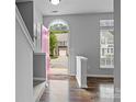 Inviting foyer with stylish flooring, staircase, and abundant natural light at 7943 Mariners Pointe Cir, Denver, NC 28037