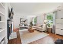 Bright living room with hardwood floors, fireplace, and two comfortable sofas at 829 Sedgefield Rd, Charlotte, NC 28209