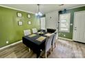 Cozy dining room with a table set for four, a fireplace, and plenty of natural light at 901 Echo Glen Rd, Charlotte, NC 28213