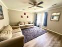 Inviting living room with light wood flooring, two cozy couches, and a view of the outdoors at 901 Echo Glen Rd, Charlotte, NC 28213